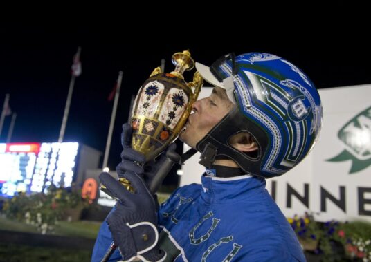 Jockey Todd McCarthy Kissing Victory Trophy