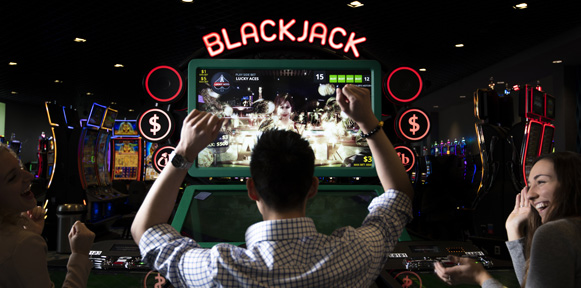 A group of people playing blackjack at Elements Casino.