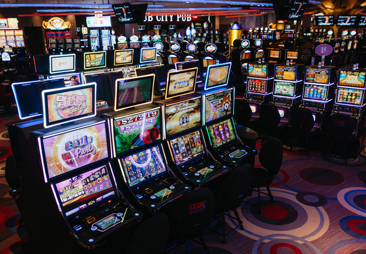 A row of River Rock slot machines in a casino.