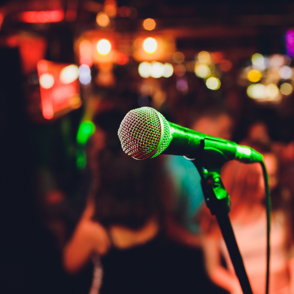 Microphone on stage with blurred background of a bar setting