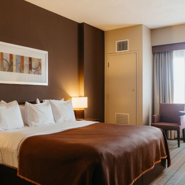 A River Rock Casino Resort hotel room with brown walls and a large bed.